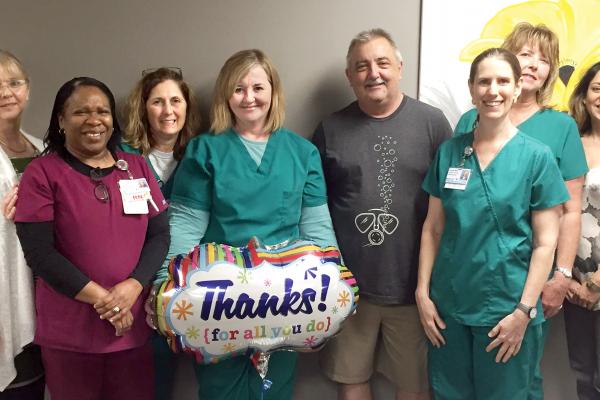 Nurses and doctors standing with patient