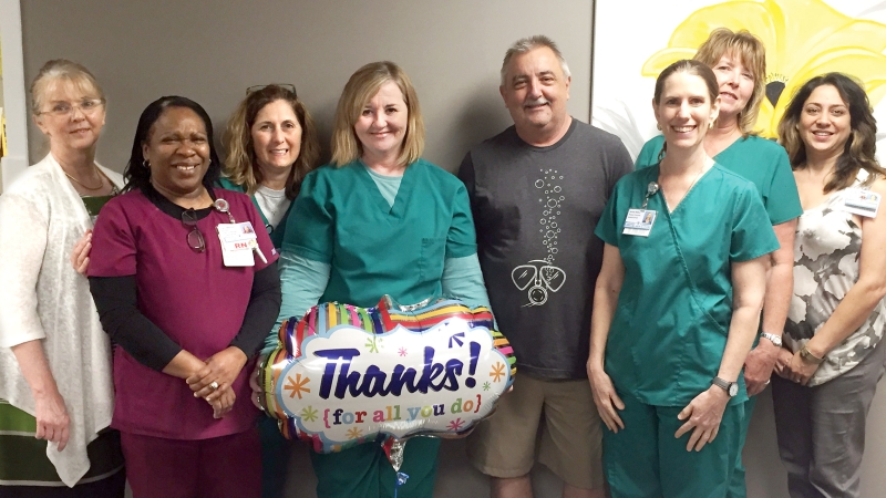 Doctors and nurses celebrating with patient 